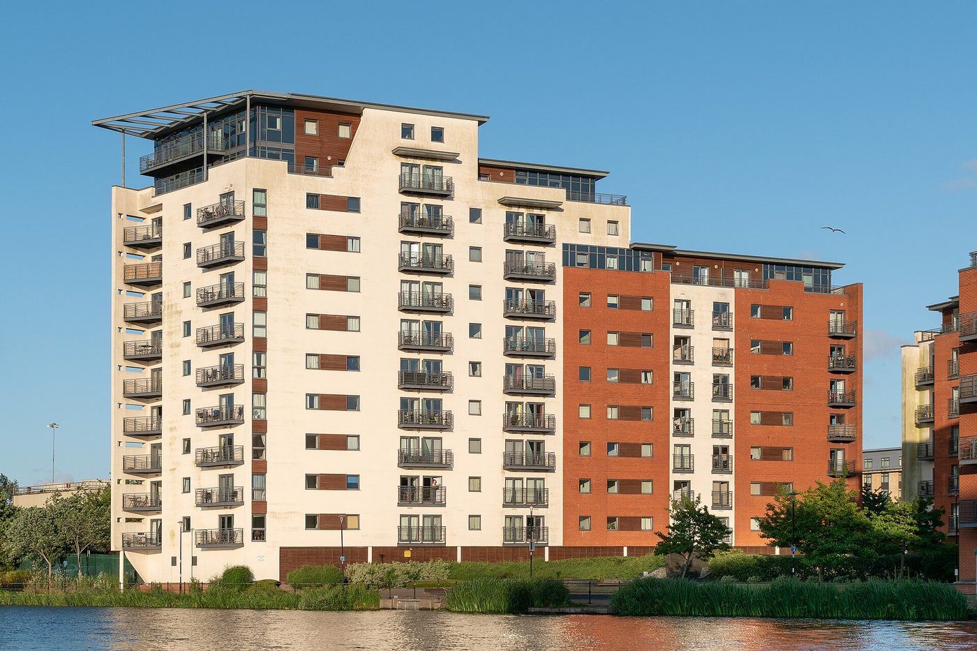 Galleon Way & The Water Quarter: The block at the southern end of Bute East Dock, water in the foreground, blue sky, 4,943px wide